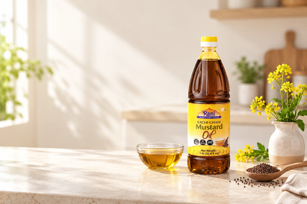 Rani Kachi Ghani Mustard Oil bottle on a sunlit cream stone counter with yellow mustard flowers and mustard seeds