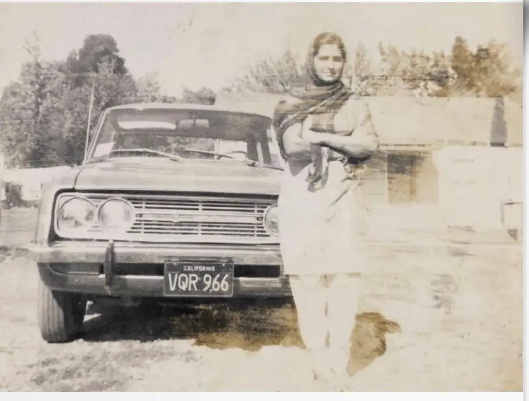 A young Phulan Chander beside the family car in California